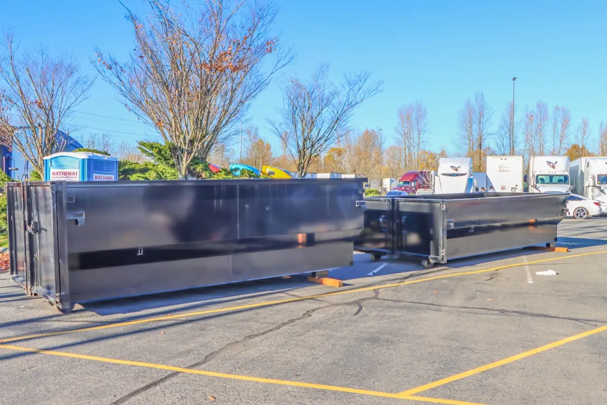 Professional dumpster rental service with roll-off container on residential driveway in Schaghticoke